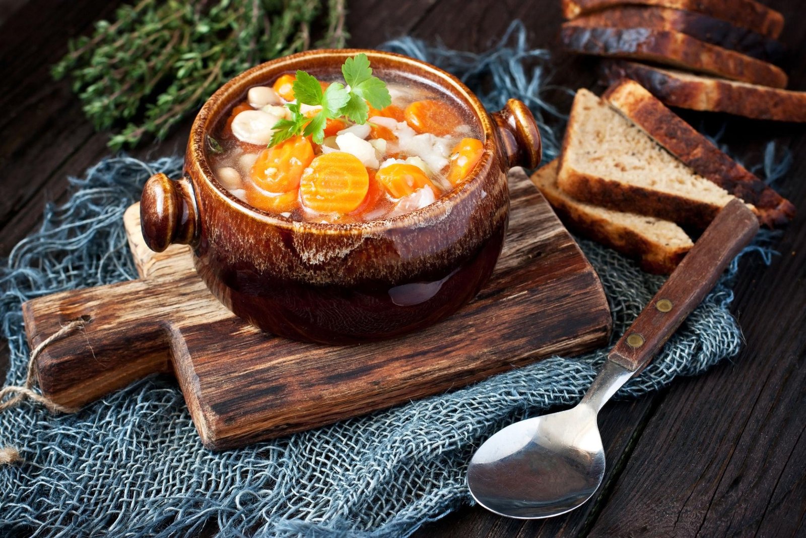 Hearty vegetable soup with carrots, potatoes, and fresh herbs in a bowl