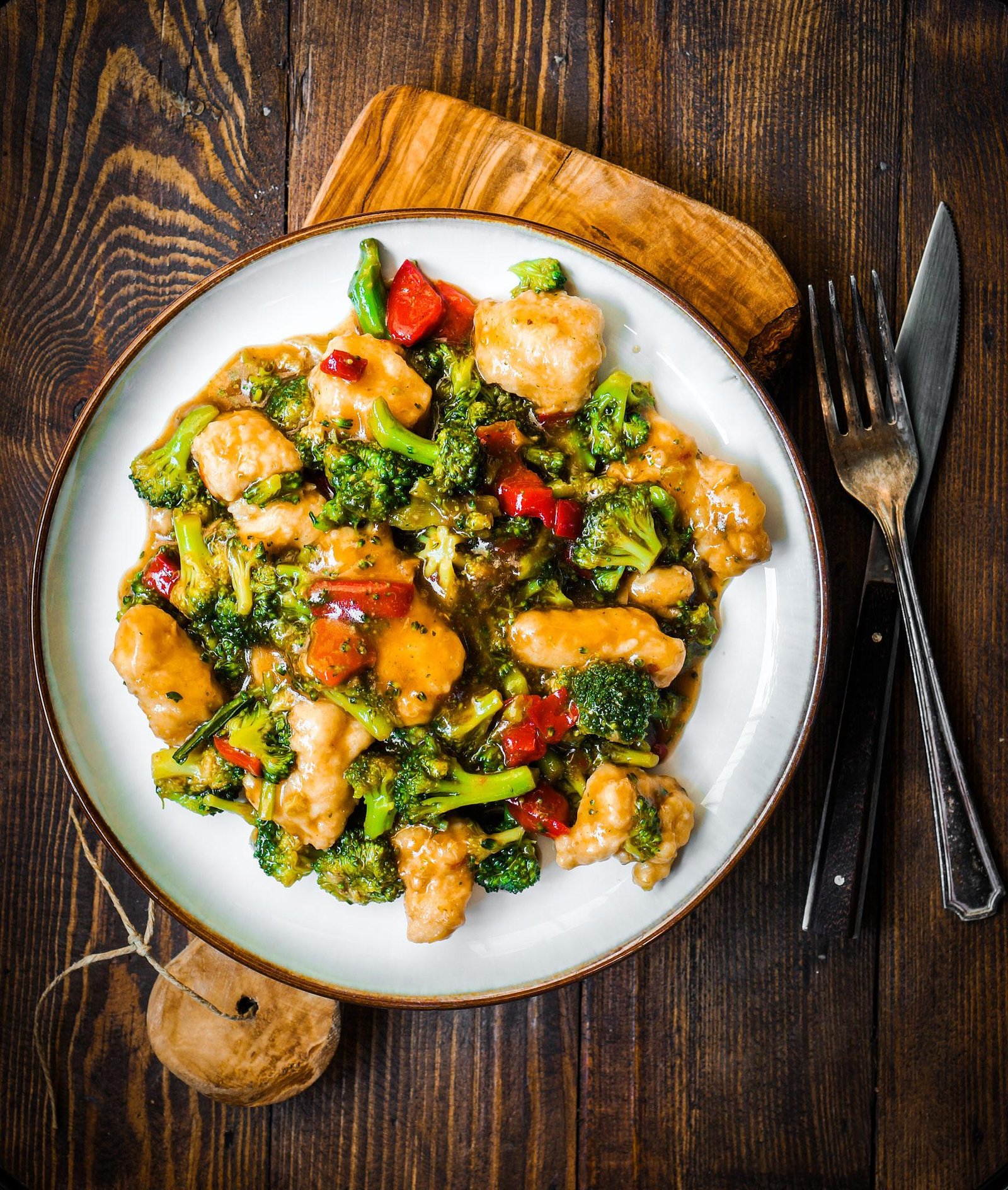 Honey garlic chicken stir fry with vegetables and glossy sauce served in a bowl