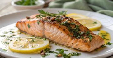 Lemon garlic butter salmon fillet with fresh herbs and lemon slices