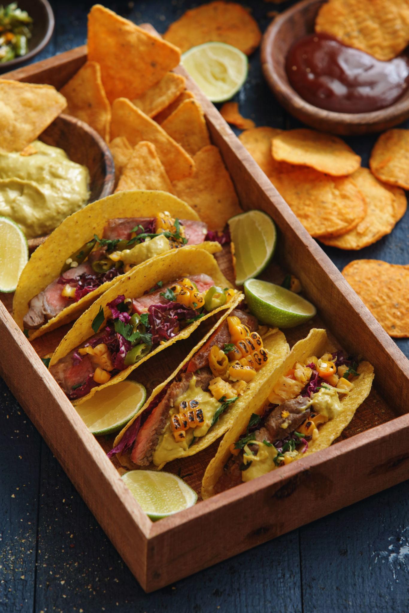 Classic beef tacos with seasoned meat, lettuce, tomatoes, and cheese