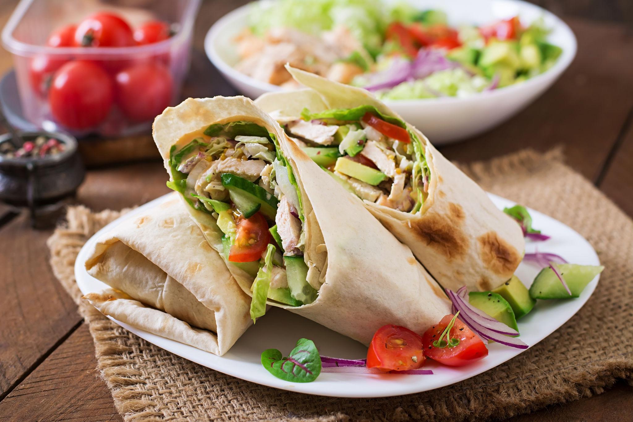 Easy chicken wrap with grilled chicken, lettuce, tomatoes, and tortilla bread