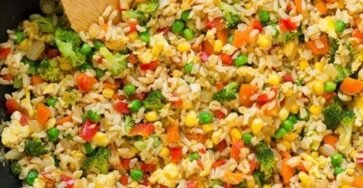 Vegetable fried rice with mixed vegetables, eggs, and soy sauce in a bowl
