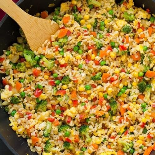 Vegetable fried rice with mixed vegetables, eggs, and soy sauce in a bowl