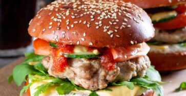 Juicy homemade beef burger with melted cheese, lettuce, and tomato
