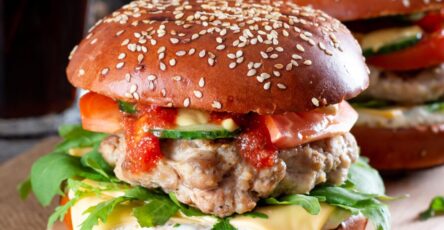 Juicy homemade beef burger with melted cheese, lettuce, and tomato