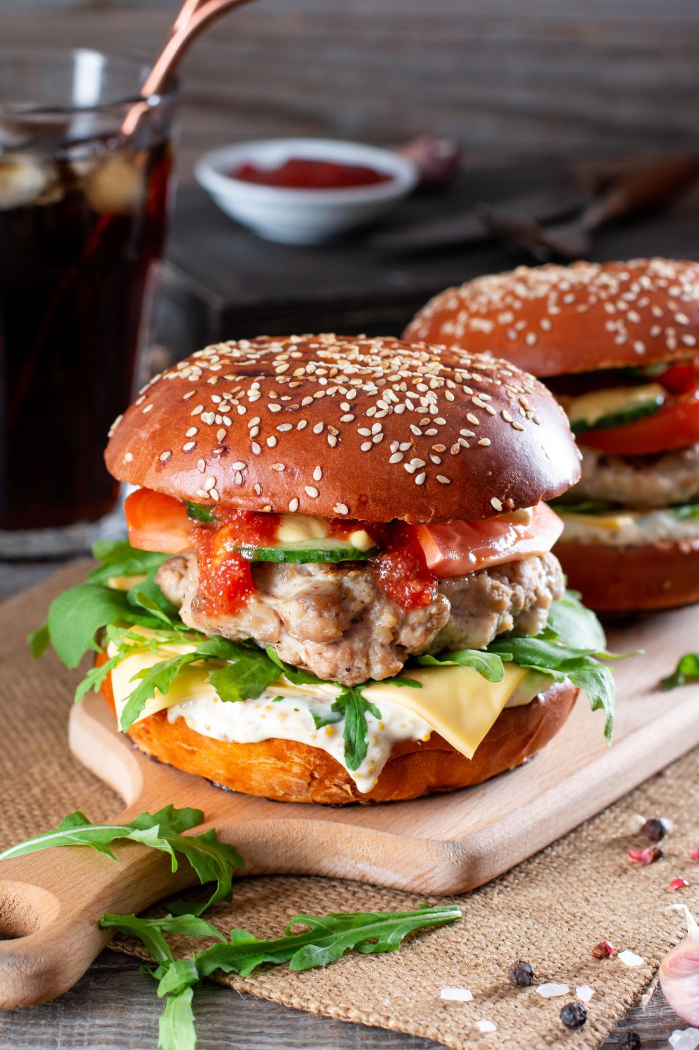 Juicy homemade beef burger with melted cheese, lettuce, and tomato