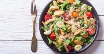 Grilled chicken Caesar salad with fresh lettuce, Parmesan cheese, and croutons