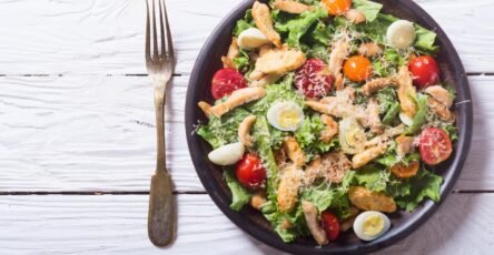 Grilled chicken Caesar salad with fresh lettuce, Parmesan cheese, and croutons