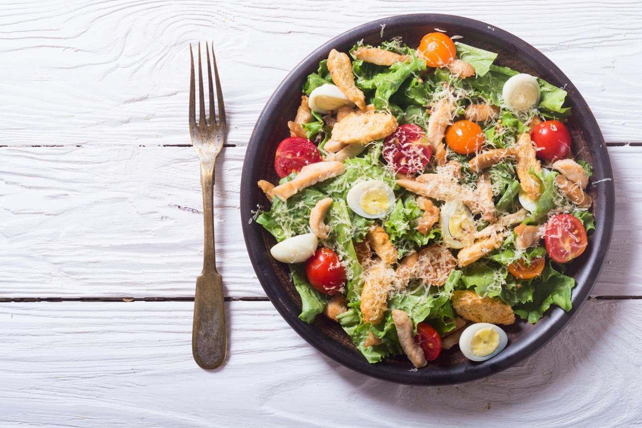 Grilled chicken Caesar salad with fresh lettuce, Parmesan cheese, and croutons