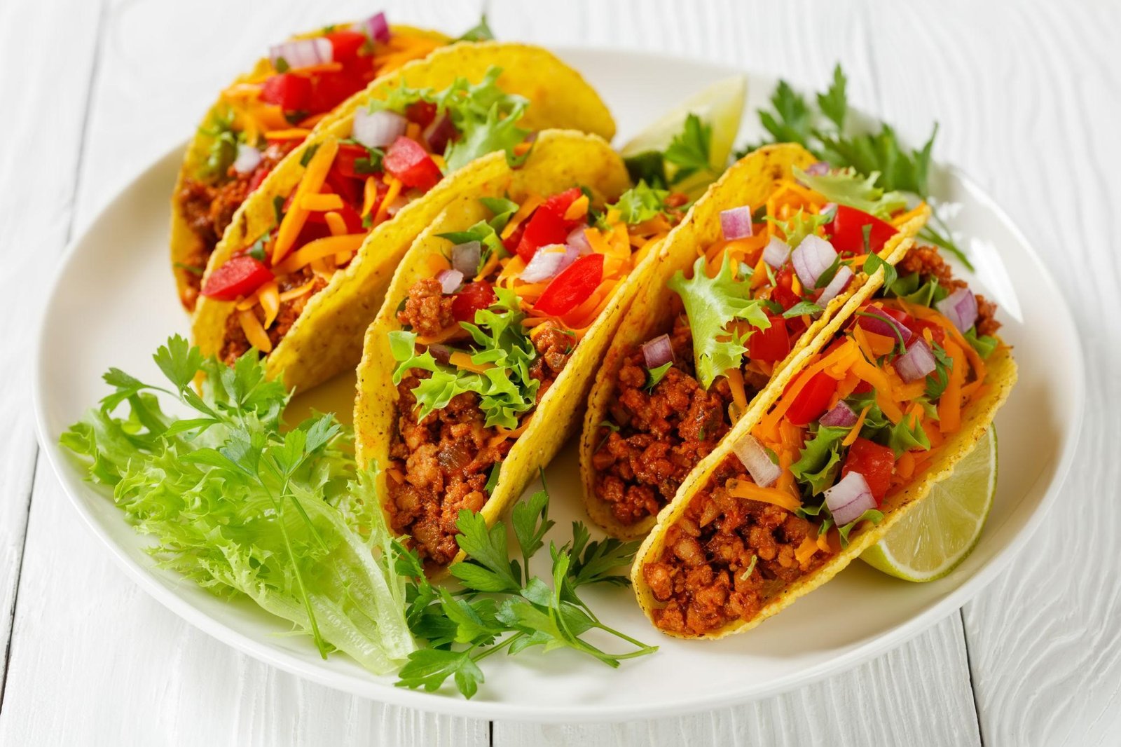 Classic beef tacos with ground beef, lettuce, cheese, and salsa in taco shells